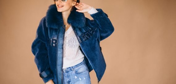 Woman model demonstrating winter cloths in a studio